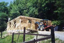 Dad Waiving and The Tractor Holding The House Up